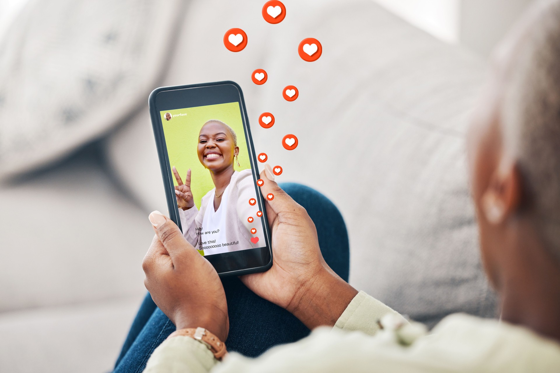 Phone screen, hands and person with social media emojis, icons and watch video, app post or influencer. Home smartphone, peace sign and user streaming vlog, content creator and relax on lounge couch